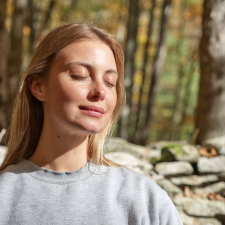 Woman meditating in woods